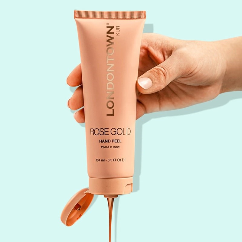 Londontown Rose Gold Hand Peel - model shown squeezing product bottle