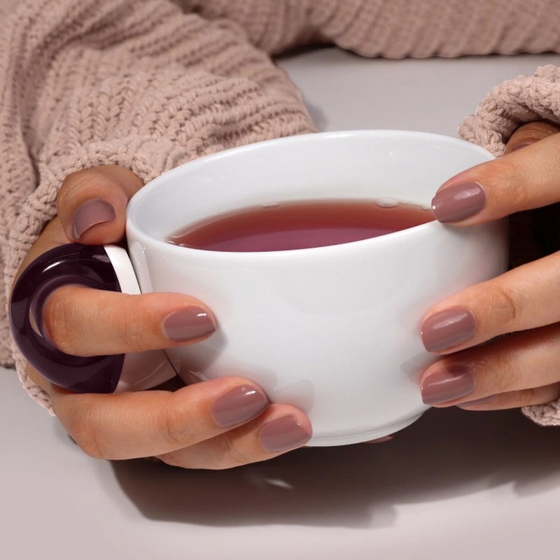 Londontown Enhanced Color - Chai - model shown with product on nails holding cup of tea