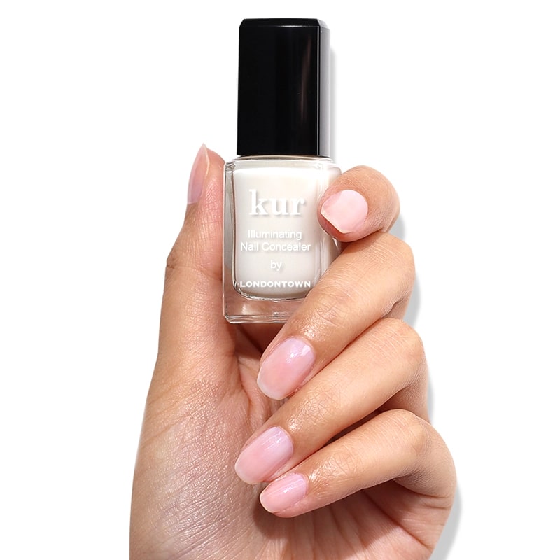 Londontown Illuminating Nail Concealer - model shown holding product 