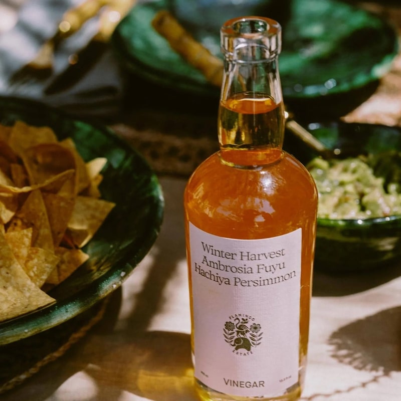 Flamingo Estate Organics Winter Harvest Persimmon Vinegar - product shown next to bowls of food