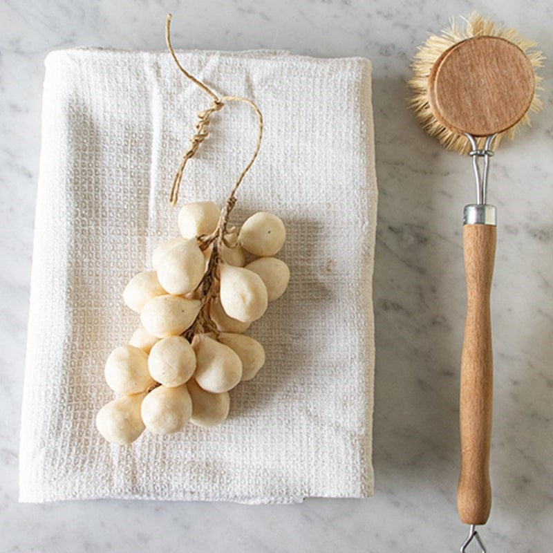 Botanopia Handcrafted Grapes Soap - Cream - product shown on towel next to brush