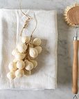 Botanopia Handcrafted Grapes Soap - Cream - product shown on towel next to brush