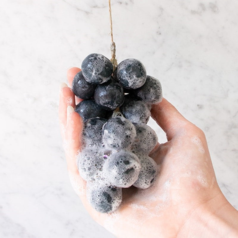 Botanopia Handcrafted Grapes Soap - Slate - model shown holding and using product