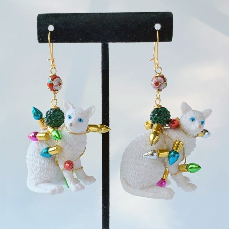 Lenora Dame Tangled in Lights Cat Holiday Earrings - products shown on earring stand