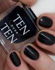 Tenoverten Nail Polish - Bond - model shown holding product with product on fingernails