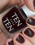 Tenoverten Nail Polish - Church - model shown holding product with product on fingernails