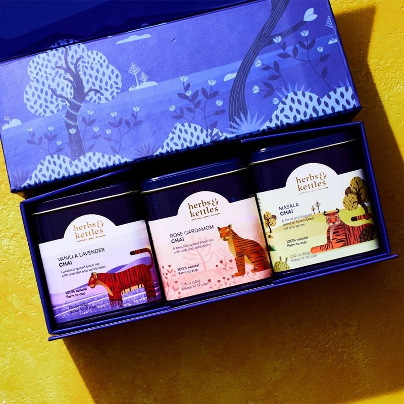 Lifestyle shot top view of Herbs & Kettles Chai Gift Set (3 pcs) showing 3 included Chai tins