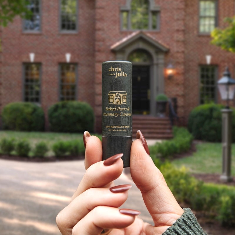 Poppy &amp; Pout Chris Loves Julia Lip Balm Trio Gift Set - model shown holding product in front of building