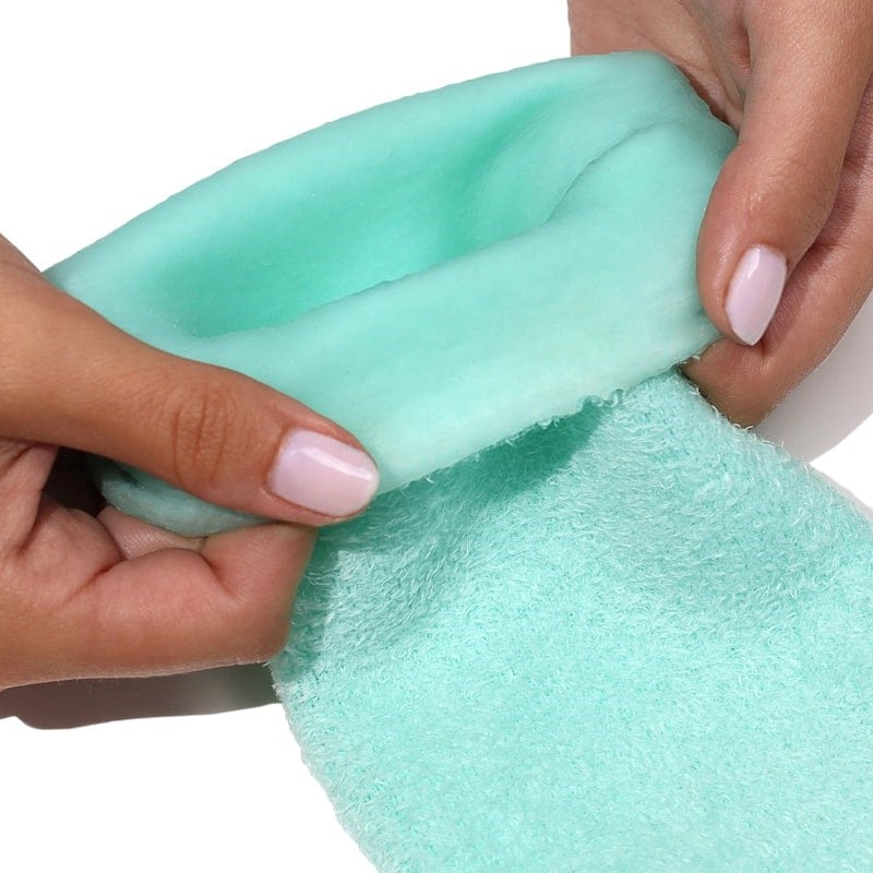 Londontown Pedi Perfect Moisturizing Spa Socks - model shown folding product inside out slightly