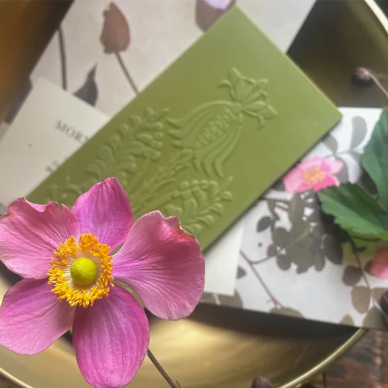 The Quiet Botanist The Matcha Rose Chocolate Bar - product shown next to flower and packaging