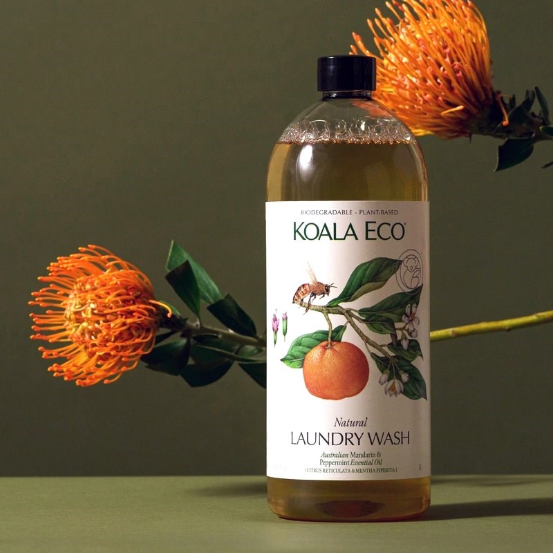 Koala Eco Natural Laundry Wash - Mandarin and Peppermint - product shown in front of flowers