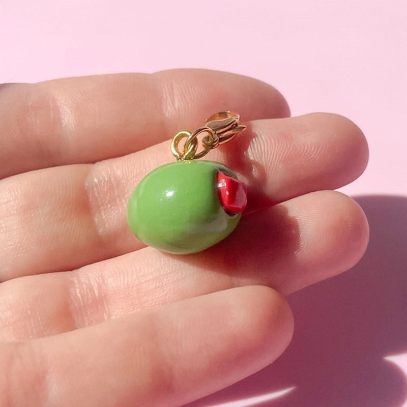 Bold Blossom Shop Olive Bag Charm - model shown holding product