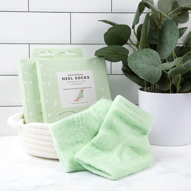 VOESH New York Moisturizing Heel Socks - Green - products shown next to packaging and potted plant