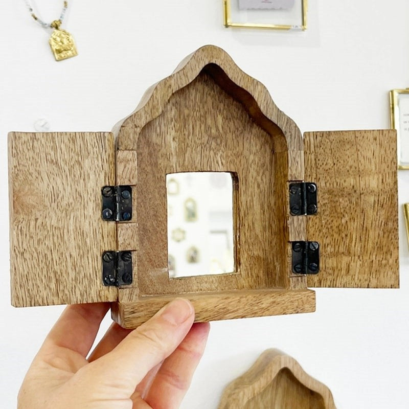 The Little Press Wooden Sanctuary with Doors and Mirror - model shown holding product with open doors