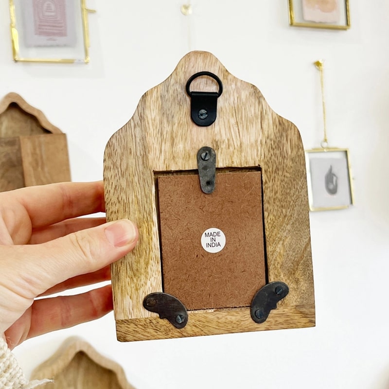 The Little Press Wooden Sanctuary with Doors and Mirror - model shown holding product showing backside