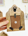 The Little Press Wooden Sanctuary with Doors and Mirror - model shown holding product showing backside