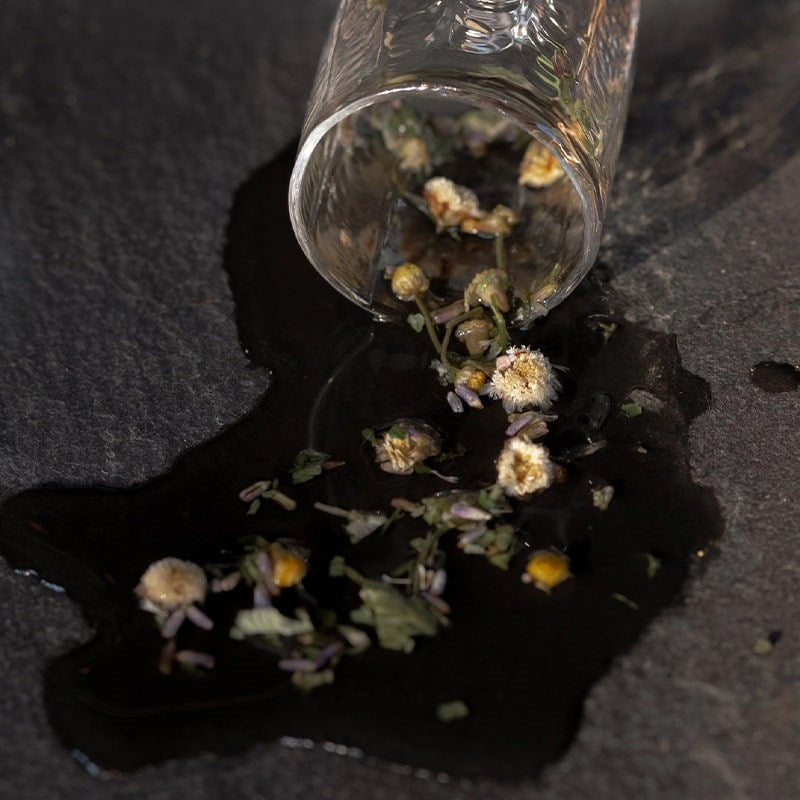 Leaves and Flowers Sleep Loose Leaf Tea - product shown with water spilling out of glass