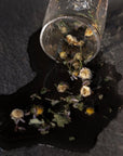 Leaves and Flowers Sleep Loose Leaf Tea - product shown with water spilling out of glass