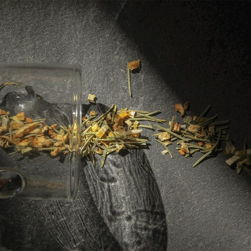 Leaves and Flowers Turmeric Wellness Loose Leaf Tea - product shown spilling out of glass