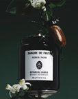 Sangre de Fruta Neroli Noir Botanical Candle - product shown with flowers and beetle 