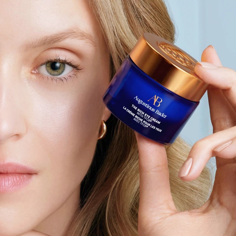 Augustinus Bader The Rich Eye Cream - model shown holding product