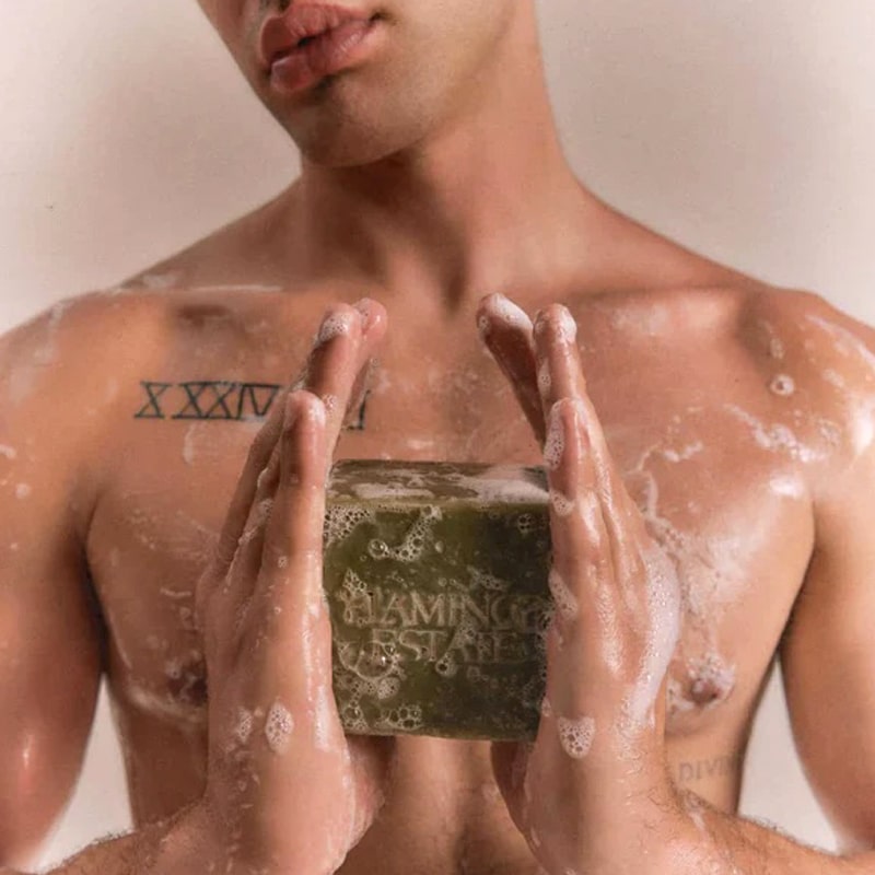 Male model holding soapy Flamingo Estate Organics Green Leaf Organic Bar Soap (340 g) and soapy torso