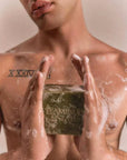 Male model holding soapy Flamingo Estate Organics Green Leaf Organic Bar Soap (340 g) and soapy torso