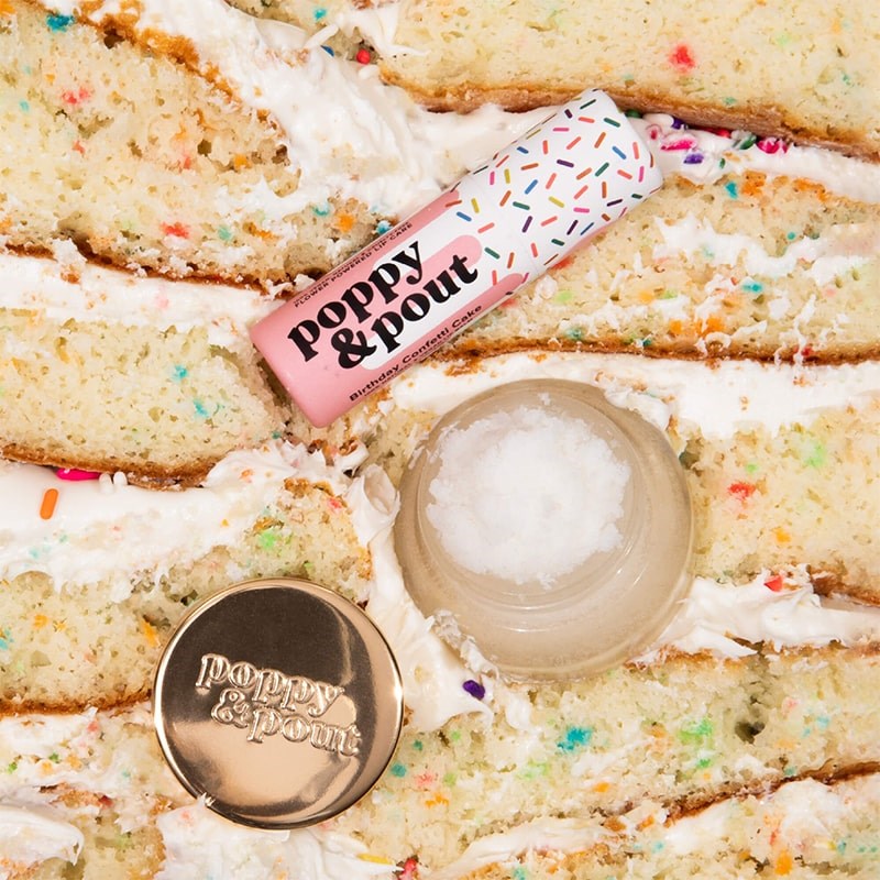 Poppy & Pout Lip Care Duo Birthday Confetti Cake - products shown on top of cake