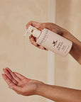 Innersense Organic Beauty Awaken Body Wash - model shown dispensing product into hand