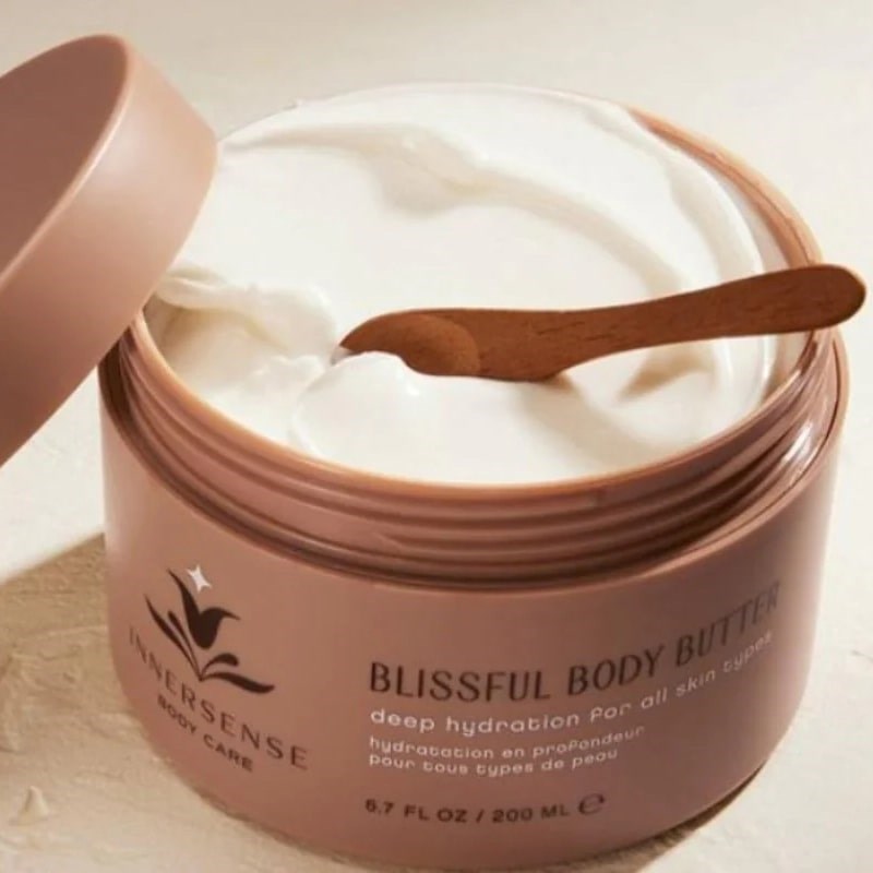 Innersense Organic Beauty Blissful Body Butter - product shown open revealing content texture and color with small spoon in it