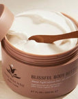 Innersense Organic Beauty Blissful Body Butter - product shown open revealing content texture and color with small spoon in it