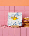 StoryTiles Small Tile - Miffy's Journey - product shown on pink bricks next to pastries