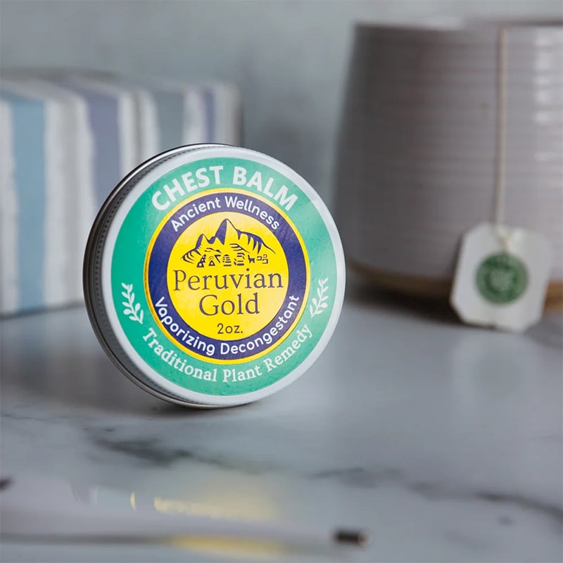 Peruvian Gold Chest Rub Balm - product shown next to cup of tea