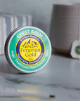 Peruvian Gold Chest Rub Balm - product shown next to cup of tea