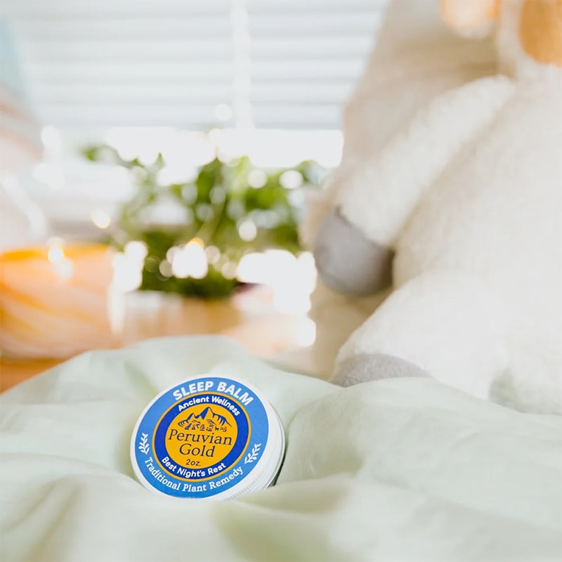 Peruvian Gold Sleep Better Balm - product shown on blanket