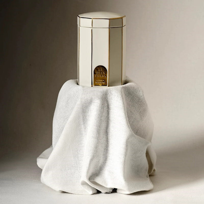 Bienaime The Candle - La Vie En Fleurs - product shown on stand with linen