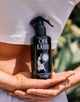 Model holding Ofa Karri Sunshine Therapy Home Spray (200 ml) behind her back