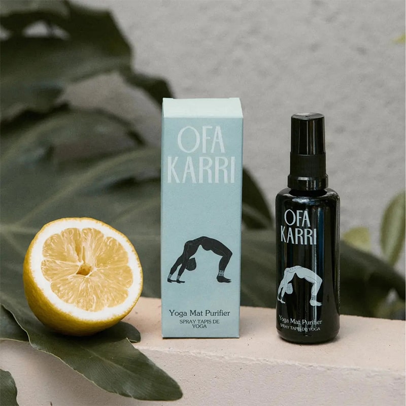 Lifestyle shot of Ofa Karri Yoga Mat Purifier (50 ml) with box and lemon next to box