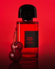 BDK Parfums Rouge Smoking Extrait Eau de Parfum - product shown next to cherries