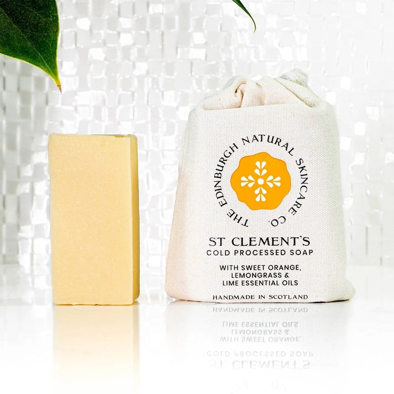 The Edinburgh Natural Skincare Company St Clements Cold Processed Soap - product shown next to packaging and leaf