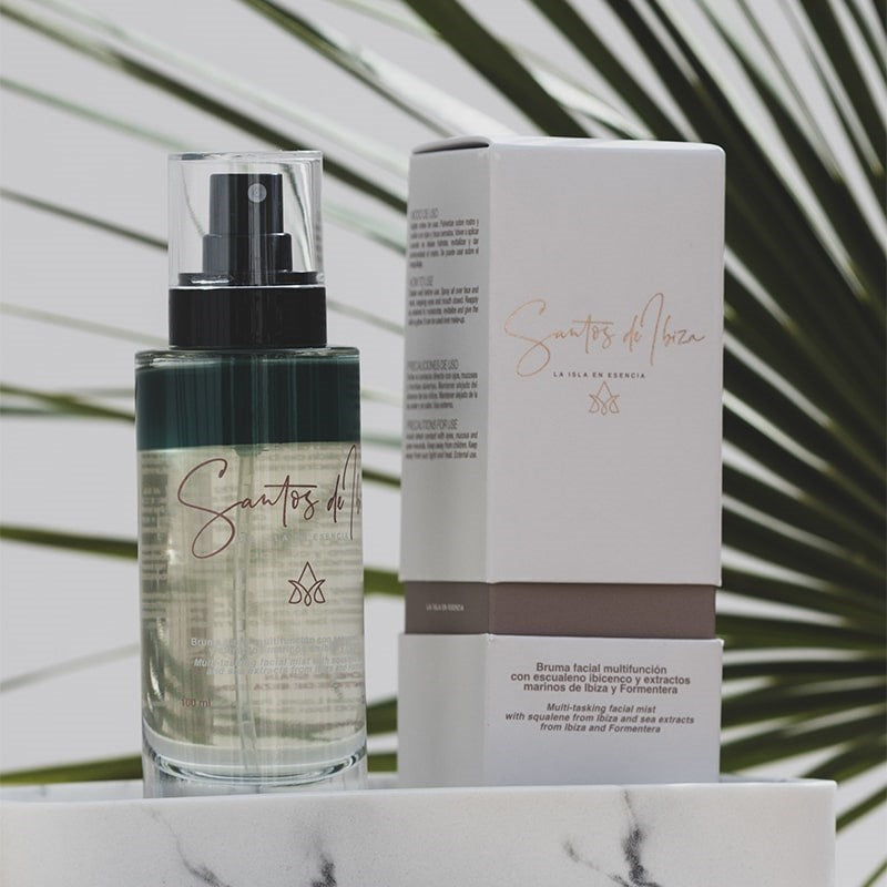 Santos de Ibiza Facial Mist (100 ml) - product shown next to packaging in front of palm leaves