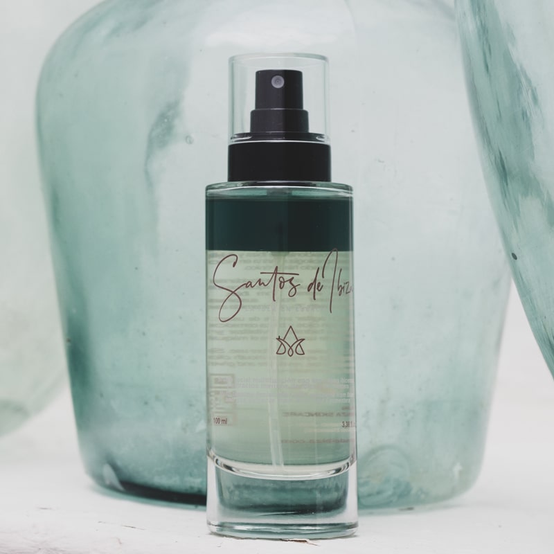 Santos de Ibiza Facial Mist (100 ml) - product shown with aqua colored glass vase in the background