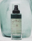 Santos de Ibiza Facial Mist (100 ml) - product shown with aqua colored glass vase in the background