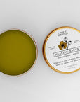 Growing Up Rooted Healing Salve - product shown opened next to lid