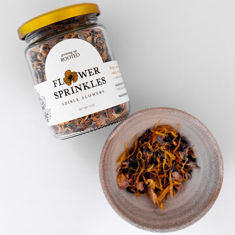 Growing Up Rooted Flower Sprinkles - product shown next to bowl of loose leaf tea