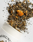 Growing Up Rooted Immunity Blend Loose Leaf Herbal Tea - product shown pouring out of packaging