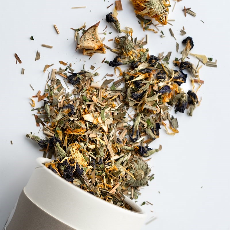 Growing Up Rooted Beauty Blend Loose Leaf Herbal Tea - product shown pouring out of packaging