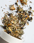 Growing Up Rooted Beauty Blend Loose Leaf Herbal Tea - product shown pouring out of packaging