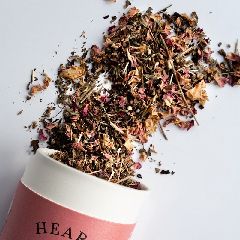 Growing Up Rooted Heart Loose Leaf Herbal Tea - product shown pouring out of packaging shown