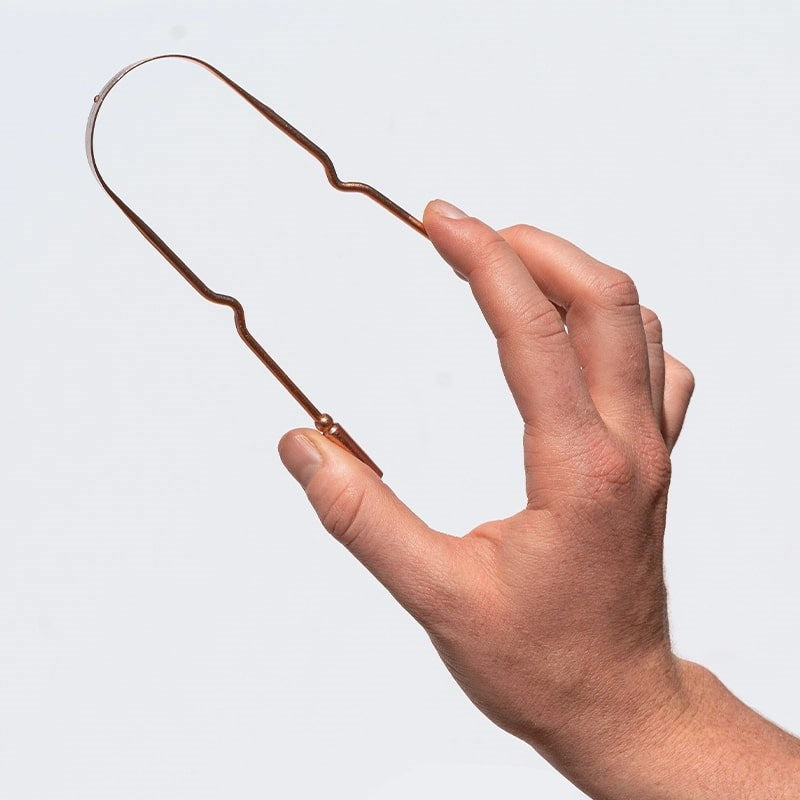 KOPPEN Pure Copper Tongue Scraper - model shown holding product